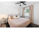 Inviting bedroom featuring neutral tones, large window, ceiling fan, and stylish décor at 376 Orange Ave, Longwood, FL 32750