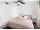 Cozy bedroom featuring a ceiling fan, light walls, a comfortable bed with throw pillows, and simple décor at 376 Orange Ave, Longwood, FL 32750