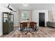 Modern dining area with stylish furniture, bright natural light, and minimalist decor at 376 Orange Ave, Longwood, FL 32750