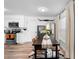 Bright dining area connected to a modern kitchen, featuring stylish decor and ample seating at 376 Orange Ave, Longwood, FL 32750