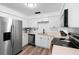 Bright kitchen with stainless steel appliances, white cabinets and countertops, and a wood-look floor at 376 Orange Ave, Longwood, FL 32750