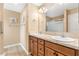 Bathroom featuring double sinks, granite countertops, wood cabinets, and a sliding glass door shower at 428 Tarrson Blvd, Lady Lake, FL 32159