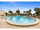 Large community pool with waterfall feature, lounge chairs, and resort-style amenities at 428 Tarrson Blvd, Lady Lake, FL 32159