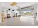 Spacious two car garage with epoxy flooring, storage shelving, and view to the outside at 428 Tarrson Blvd, Lady Lake, FL 32159
