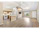 Open-concept living room boasts wood floors, abundant natural light, and seamless integration with kitchen area at 428 Tarrson Blvd, Lady Lake, FL 32159