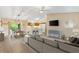 Open-concept living room with a modern kitchen, dining area, and sliding glass doors to a screened lanai at 428 Tarrson Blvd, Lady Lake, FL 32159