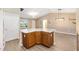 Open-concept floor plan features a peninsula with a view of the living area and wood-look flooring at 428 Tarrson Blvd, Lady Lake, FL 32159