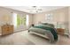 Brightly lit main bedroom with a large window and ensuite bath at 428 Tarrson Blvd, Lady Lake, FL 32159