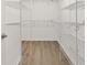 Spacious walk-in closet with wire shelving and laminate flooring at 428 Tarrson Blvd, Lady Lake, FL 32159