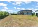 A spacious backyard featuring a screened-in patio and black metal fence at 4599 Storytelling Way, Kissimmee, FL 34746
