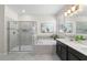 Bright bathroom featuring a separate shower and tub, complemented by a modern vanity with double sinks at 4599 Storytelling Way, Kissimmee, FL 34746