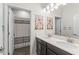 Bathroom featuring a double vanity with dark cabinets, tile floors, and a shower-tub combo with a curtain at 4599 Storytelling Way, Kissimmee, FL 34746