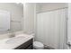 Neutral bathroom showcases vanity with solid surface countertop, white shower curtain, and clean finishes at 4599 Storytelling Way, Kissimmee, FL 34746