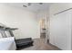 Bedroom with exercise equipment is carpeted and features closet and access to hallway at 4599 Storytelling Way, Kissimmee, FL 34746