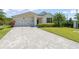 Charming single-story home with a two-car garage, paver driveway and manicured landscaping at 4599 Storytelling Way, Kissimmee, FL 34746