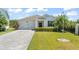 Charming one-story home featuring a well-manicured lawn, a paver driveway, and an attached two-car garage at 4599 Storytelling Way, Kissimmee, FL 34746