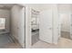 Hallway view leading to a sunlit bedroom, showcasing the home's open layout and modern design at 4599 Storytelling Way, Kissimmee, FL 34746