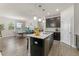 This stunning kitchen features stainless steel appliances, dark cabinets, and a large center island with seating at 4599 Storytelling Way, Kissimmee, FL 34746