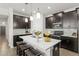 Beautiful kitchen with stainless steel appliances, dark cabinetry, and a center island perfect for entertaining at 4599 Storytelling Way, Kissimmee, FL 34746