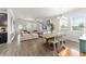 Spacious living area with abundant natural light, and hardwood flooring leads to dining area at 4599 Storytelling Way, Kissimmee, FL 34746