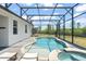 Inviting pool and spa area within a screened enclosure and views of nature at 4599 Storytelling Way, Kissimmee, FL 34746