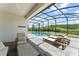 Inviting pool and spa area within a screened enclosure, offering a private outdoor oasis at 4599 Storytelling Way, Kissimmee, FL 34746