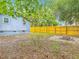 Backyard features a new fence, mature trees and a cozy fire pit at 499 W Beresford Rd, Deland, FL 32720