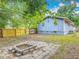 Backyard featuring home, new fence, mature trees and a cozy fire pit at 499 W Beresford Rd, Deland, FL 32720