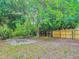 Backyard features a new fence, mature trees and a cozy fire pit at 499 W Beresford Rd, Deland, FL 32720