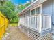 Home's backyard featuring a small deck overlooking yard and new fence at 499 W Beresford Rd, Deland, FL 32720