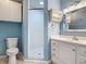 Bright bathroom boasts a modern vanity, decorative mirror, and tiled shower at 499 W Beresford Rd, Deland, FL 32720