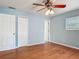 Comfortable bedroom featuring hardwood floors, a ceiling fan, and a window at 499 W Beresford Rd, Deland, FL 32720