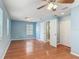 Spacious bedroom featuring hardwood floors, two closets, and a ceiling fan at 499 W Beresford Rd, Deland, FL 32720