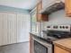Kitchen featuring a stainless steel range and access to the outdoor living space at 499 W Beresford Rd, Deland, FL 32720