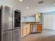 View of the kitchen featuring stainless steel appliances and a pass through to the living area at 499 W Beresford Rd, Deland, FL 32720