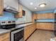Spacious kitchen featuring oak cabinets, stainless steel appliances, and ample counter space at 499 W Beresford Rd, Deland, FL 32720