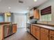Open kitchen area with a dishwasher, stainless steel appliances, and plenty of cabinets at 499 W Beresford Rd, Deland, FL 32720