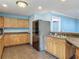 Well-lit kitchen boasts modern stainless steel refrigerator and plenty of cabinet storage at 499 W Beresford Rd, Deland, FL 32720