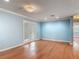 Bright living room showcasing hardwood floors, French doors, and light blue walls at 499 W Beresford Rd, Deland, FL 32720