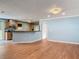 Open-concept living area with hardwood floors leading into the kitchen area with wood cabinetry at 499 W Beresford Rd, Deland, FL 32720