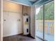 Utility room with a water heater and access to the outdoor deck at 499 W Beresford Rd, Deland, FL 32720