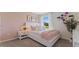 Cozy bedroom with pink accents, inviting natural light and a comfortable ambiance at 5075 Marshelder, Apopka, FL 32712