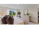 Relaxing bedroom featuring a comfortable bed, dresser, and a window overlooking a green lawn at 5075 Marshelder, Apopka, FL 32712