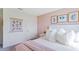 Bright bedroom features a white bed frame, floral wall art, and neutral decor at 5075 Marshelder, Apopka, FL 32712