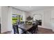 Elegant dining area with natural light, a view of the backyard, and stylish modern decor at 5075 Marshelder, Apopka, FL 32712