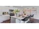 Kitchen island featuring bar stools, stainless appliances, granite countertops, and white cabinets at 5075 Marshelder, Apopka, FL 32712