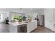 Open-concept kitchen with an island, stainless steel appliances, and views of the backyard at 5075 Marshelder, Apopka, FL 32712