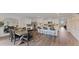 Bright, open-concept kitchen with stainless steel appliances, an island with bar seating, and an adjacent dining area at 5075 Marshelder, Apopka, FL 32712