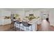Modern kitchen with white cabinets, a large island with bar seating, and stainless steel appliances at 5075 Marshelder, Apopka, FL 32712