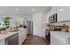 Bright kitchen featuring stainless steel appliances, white cabinetry, and modern finishes at 5075 Marshelder, Apopka, FL 32712